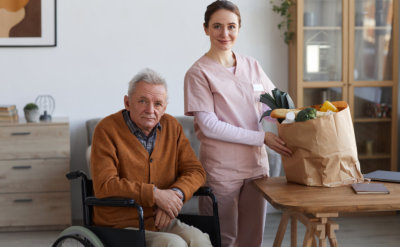 senior man with caretaker with groceries