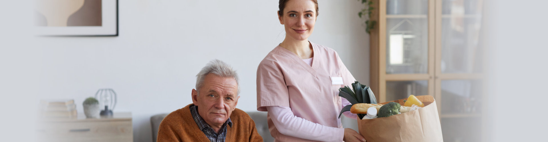 senior man with caretaker with groceries