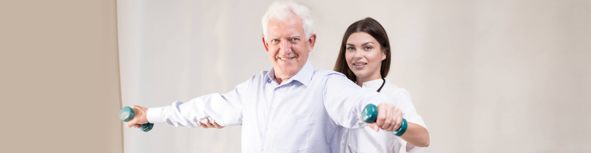 senior man doing exercise with caretaker